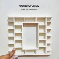 A bookcase, primed white